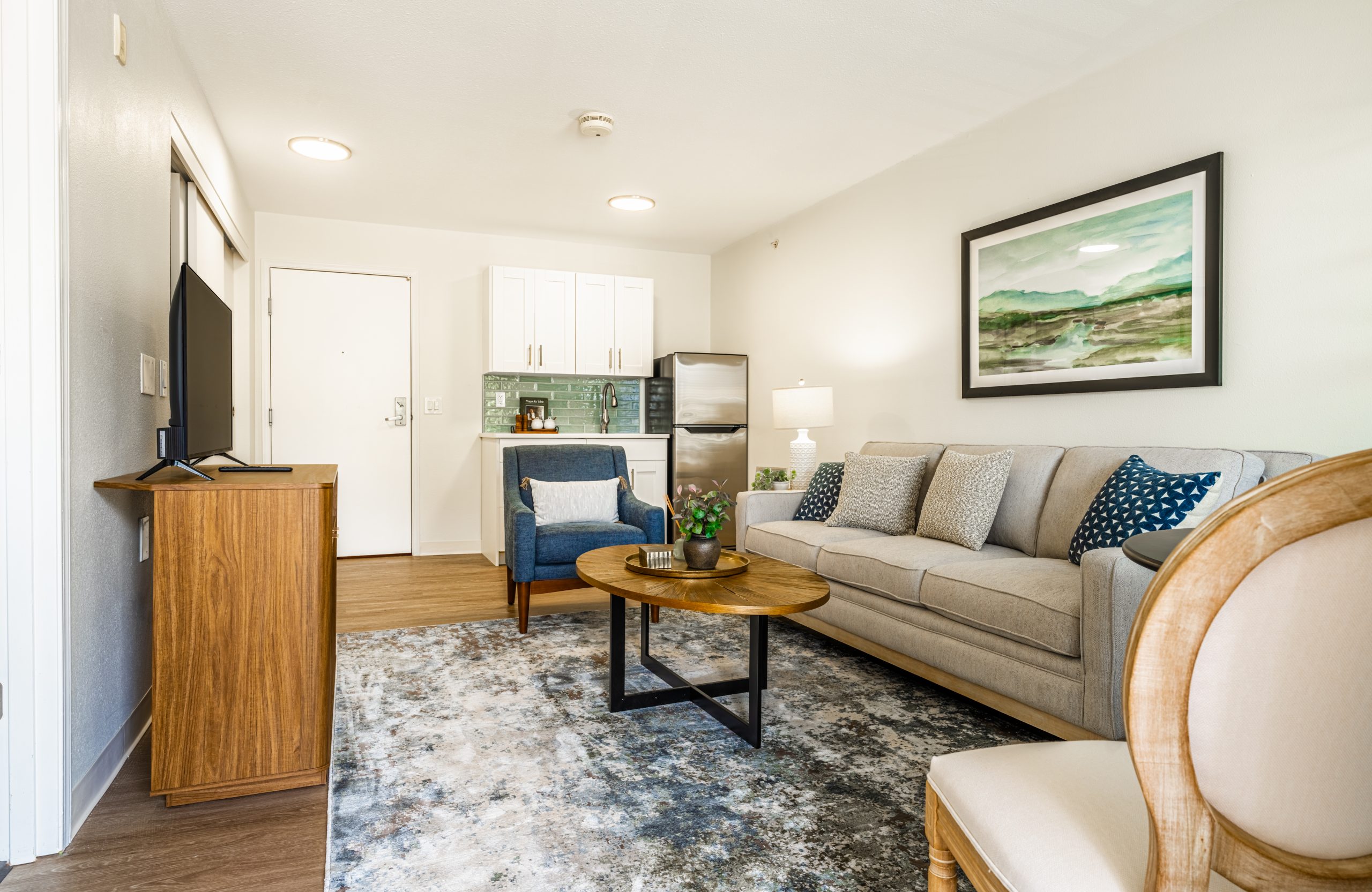 Newly renovated apartment living space and kitchenette at Curtis Creek Senior Living in Quincy, Illinois, completed in 2025.