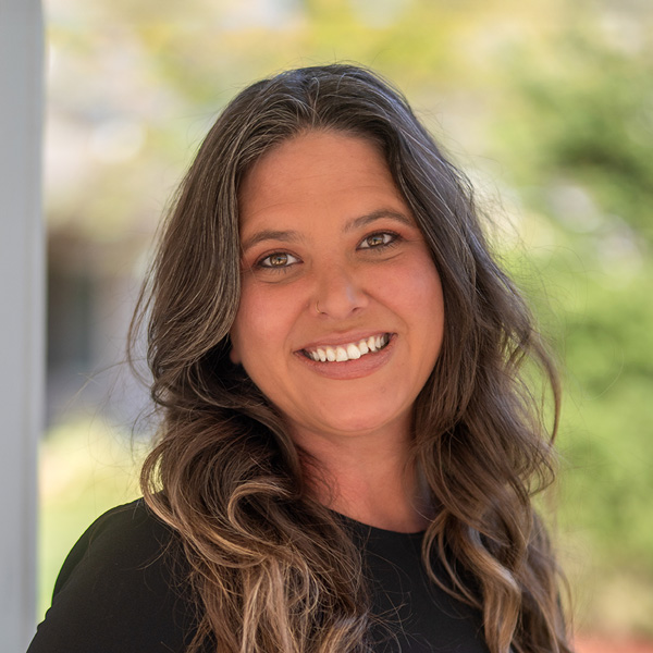 Stacy Lamborn, Business Operations Director at Curtis Creek Senior Living, smiling in a professional outdoor headshot with a softly blurred background.